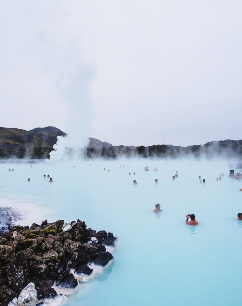 Daytime picture of the blue lagoon showing people bathing in the water